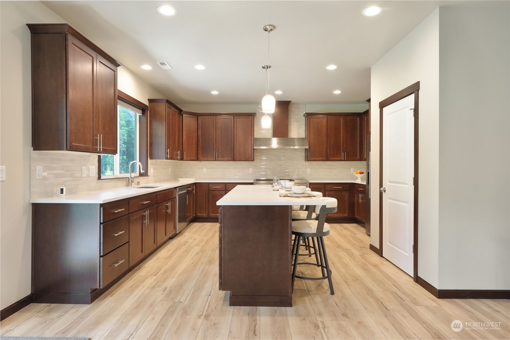 36016 Mann Road Sultan, WA 98294 - Photo 9 of 39 a kitchen with kitchen island a sink stove and wooden cabinets