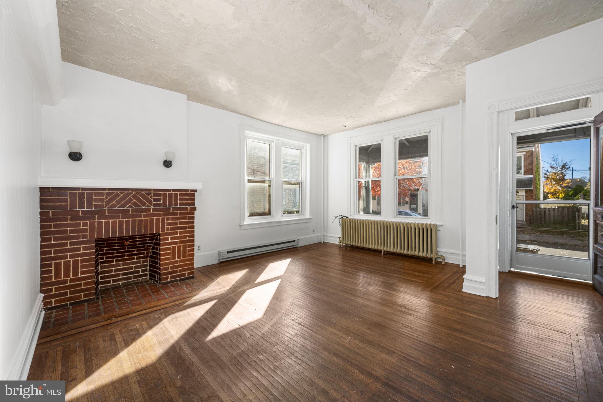 23 East 2nd Street, Unit 1 Pottstown, PA 19464 - Photo 1 of 15 a view of an empty room with wooden floor and a window