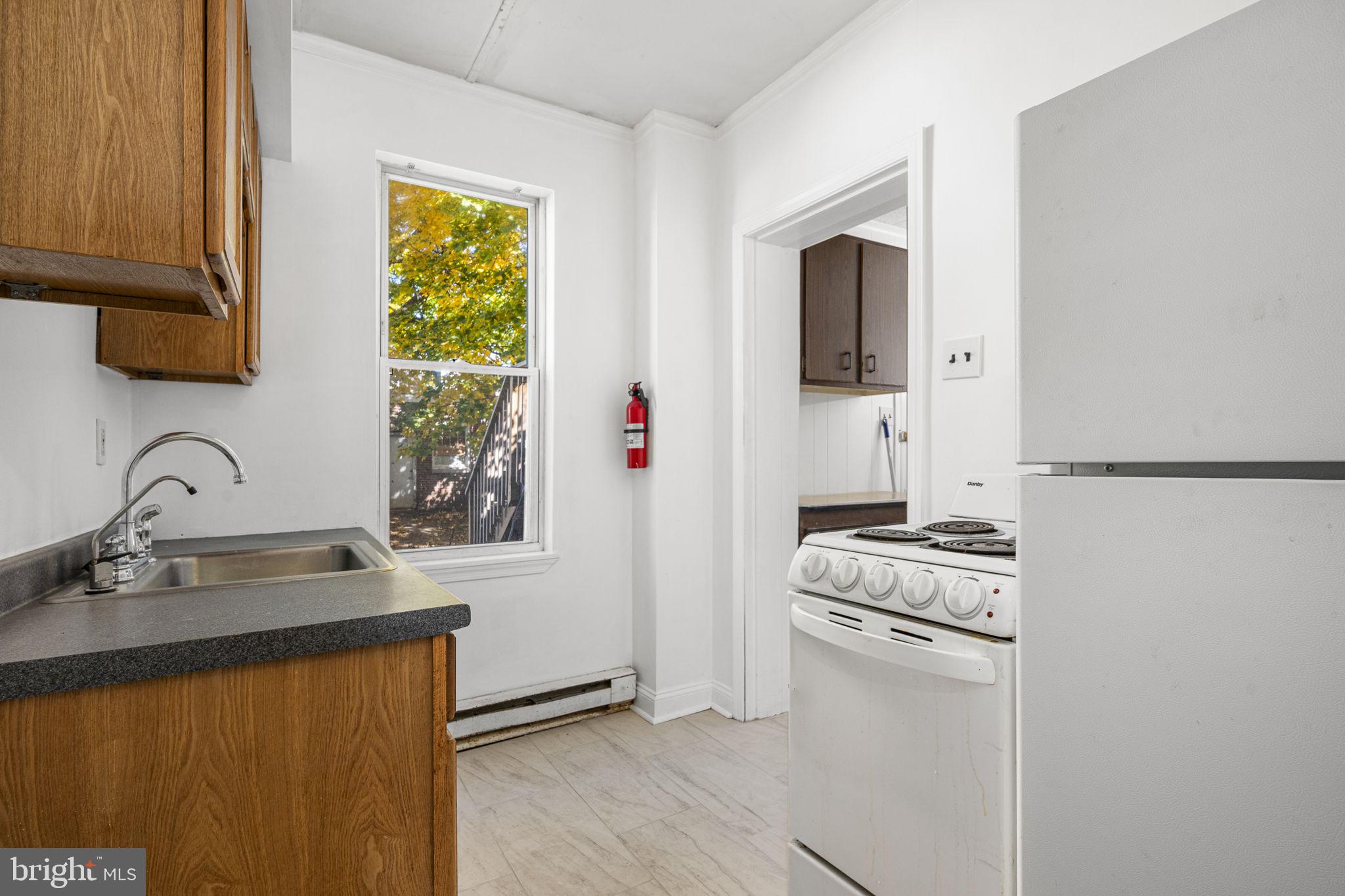 23 East 2nd Street, Unit 1 Pottstown, PA 19464 - Photo 11 of 15 a kitchen with stainless steel appliances granite countertop a sink stove and refrigerator