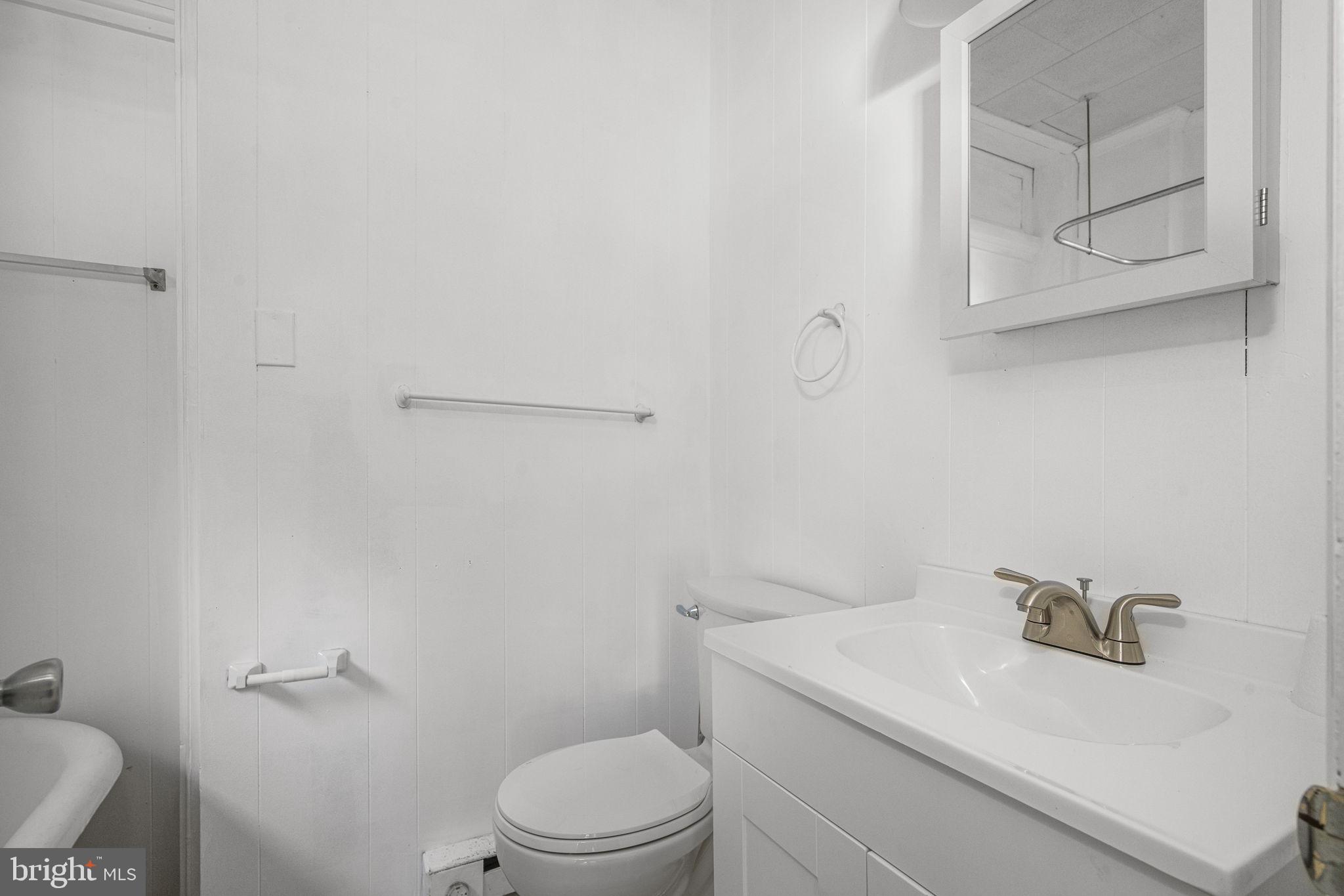 23 East 2nd Street, Unit 1 Pottstown, PA 19464 - Photo 14 of 15 a white toilet sitting next to a bathroom sink