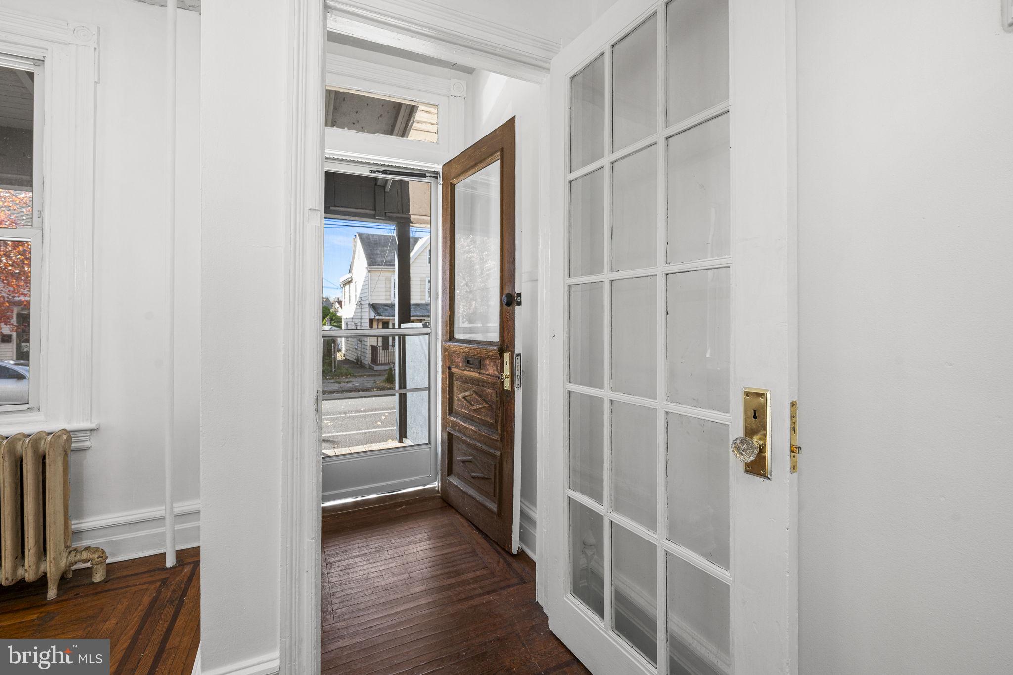 23 East 2nd Street, Unit 1 Pottstown, PA 19464 - Photo 4 of 15 a view of a hallway with wooden floor and staircase