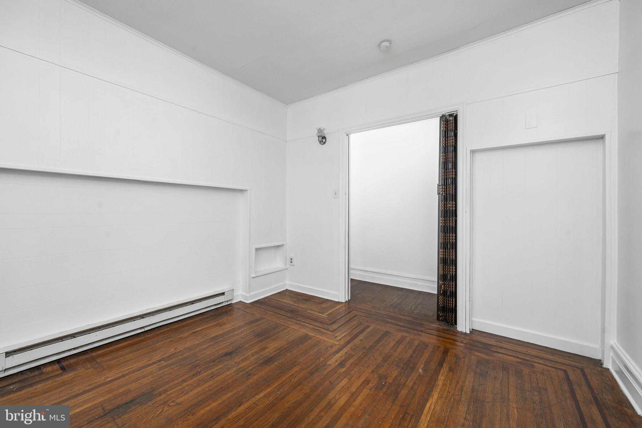 23 East 2nd Street, Unit 1 Pottstown, PA 19464 - Photo 8 of 15 an empty room with wooden floor