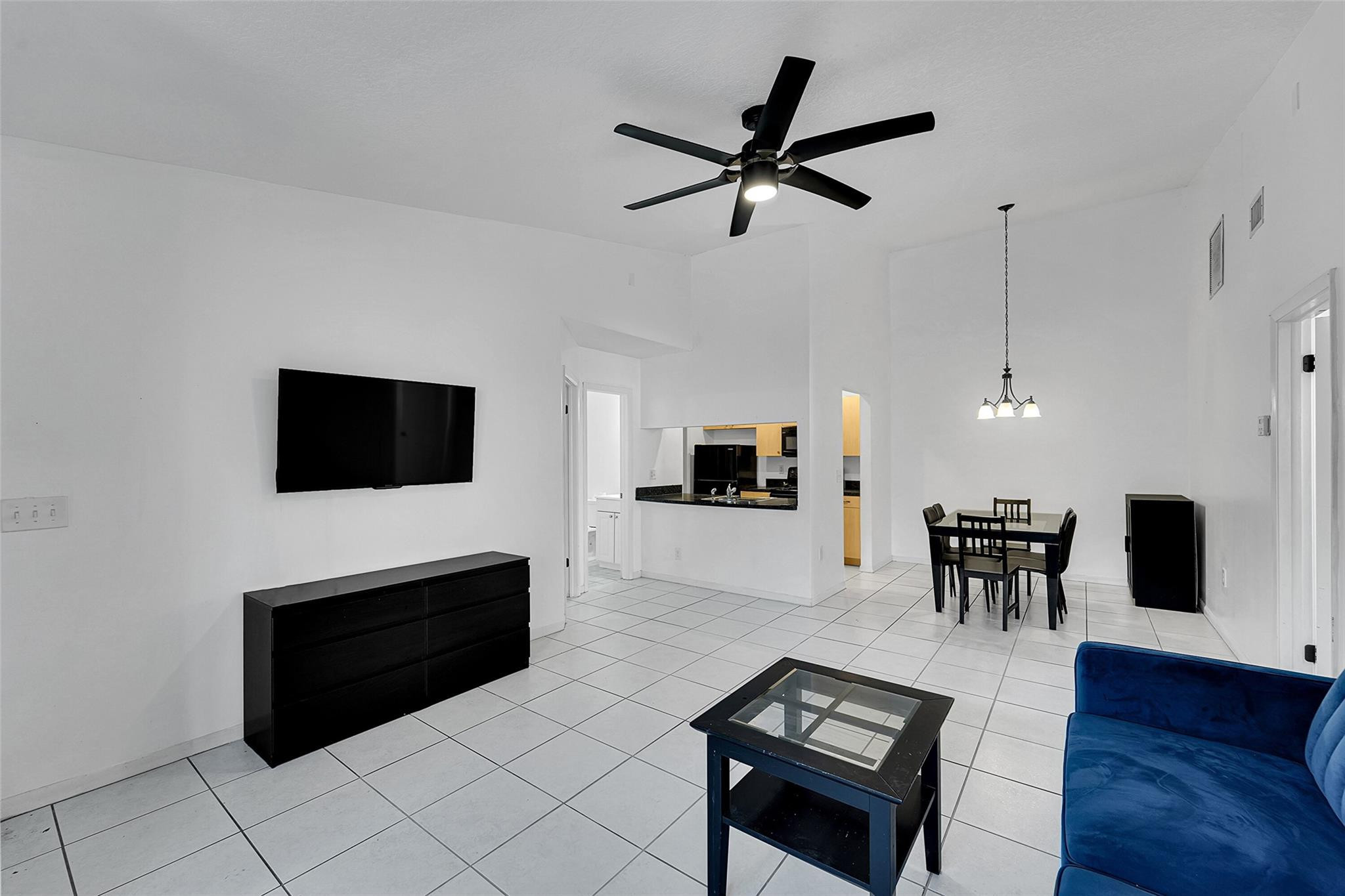 2698 North Nob Hill Road Sunrise, FL 33322 - Photo 3 of 27 a living room with furniture and a flat screen tv