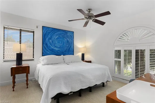 a bedroom with a large bed and a window