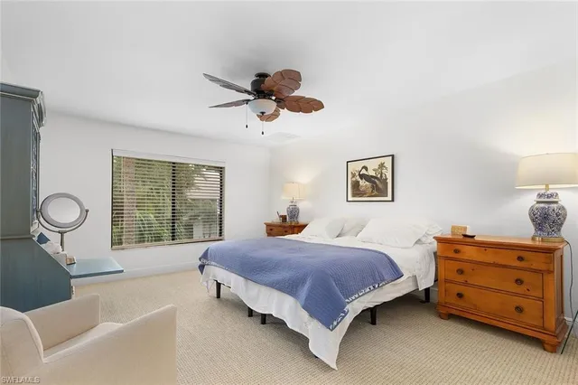 a bedroom with a bed and dresser with mirror