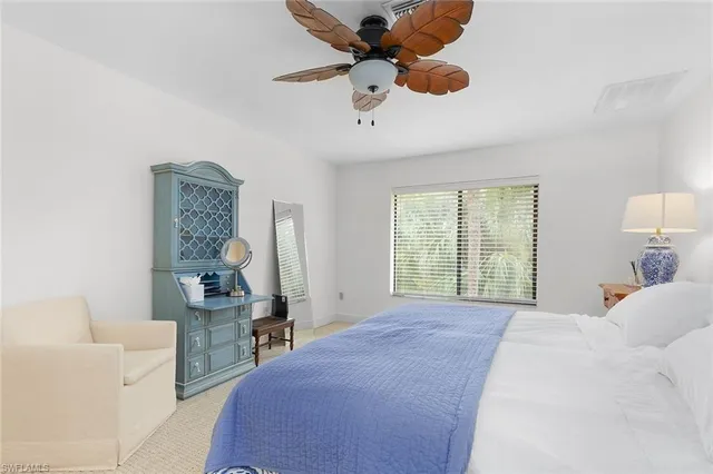 a bed room with a bed and a chandelier