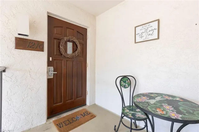 a view of a hallway with furniture and a mirror