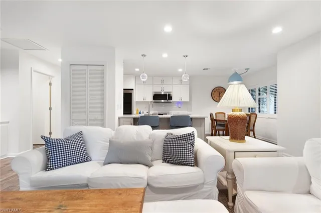 a living room with a couch and kitchen view