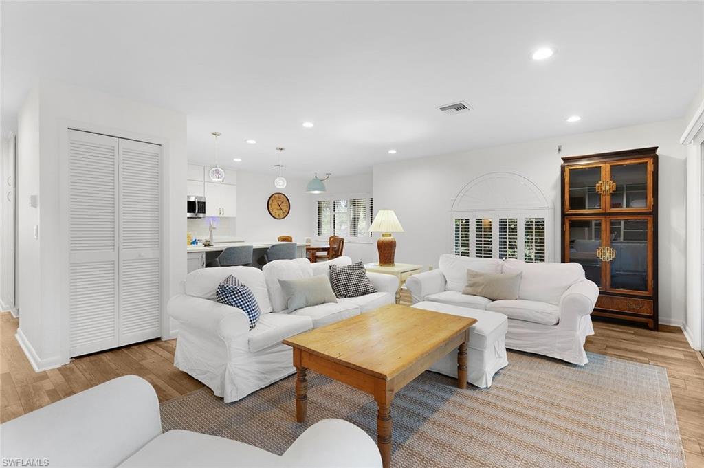 3360 10th Street North, Unit 1210 Naples, FL 34103 - Photo 4 of 28 a living room with furniture and a table