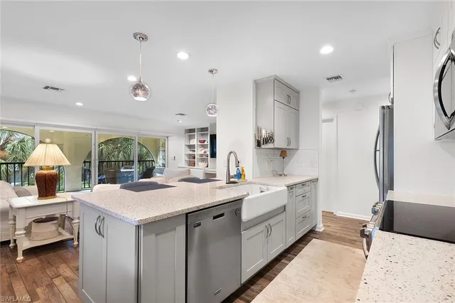 a large white kitchen with a large window