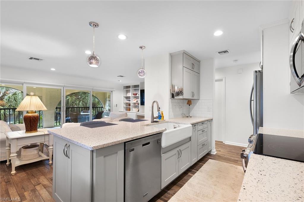 3360 10th Street North, Unit 1210 Naples, FL 34103 - Photo 6 of 28 a large white kitchen with a large window