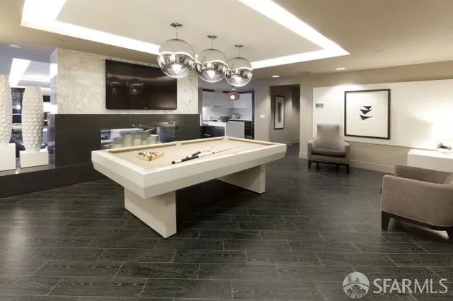 a room with pool table and flat screen tv