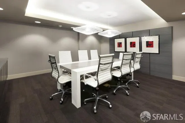 a view of a dining room with a table and chairs