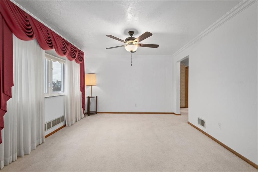 463 1st Street Pittsburgh, PA 15227 - Photo 4 of 20 a view of a hallway with a chandelier fan and windows