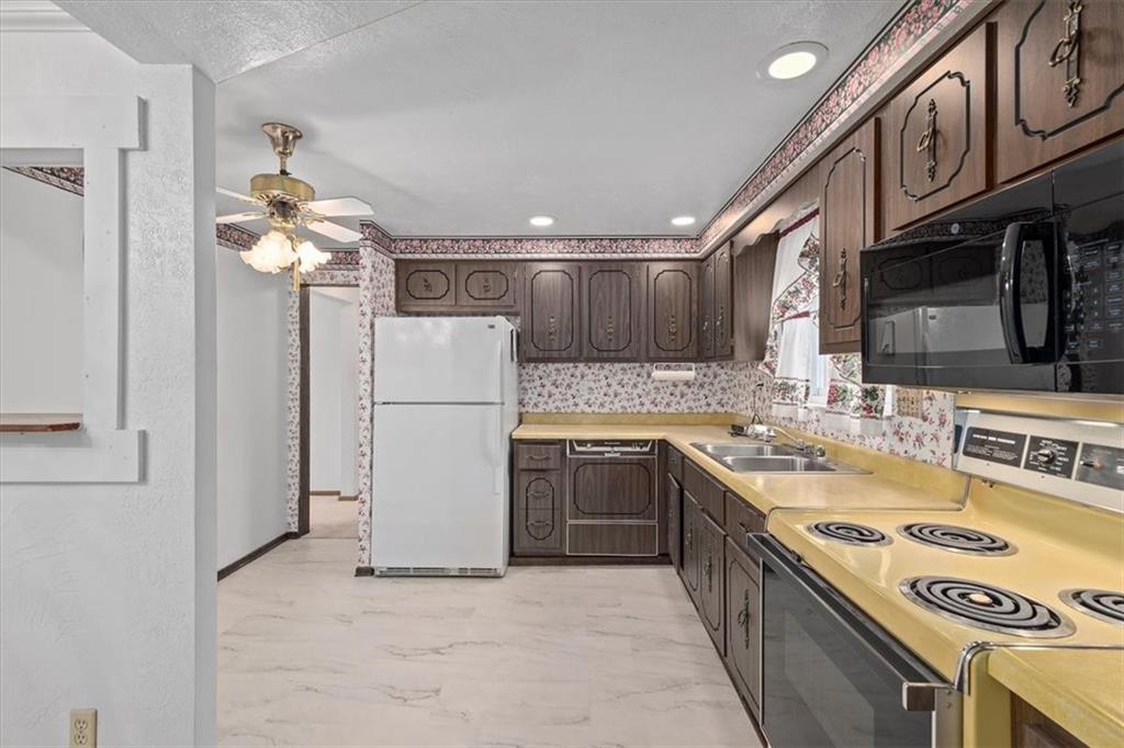463 1st Street Pittsburgh, PA 15227 - Photo 8 of 20 a kitchen with a sink a refrigerator and a stove top oven