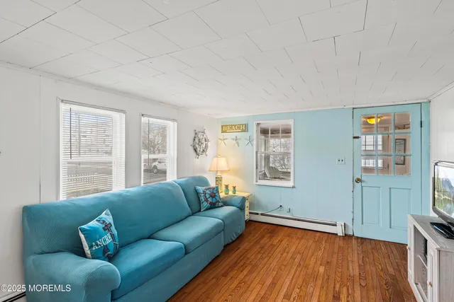 a bedroom with a bed and next to a window