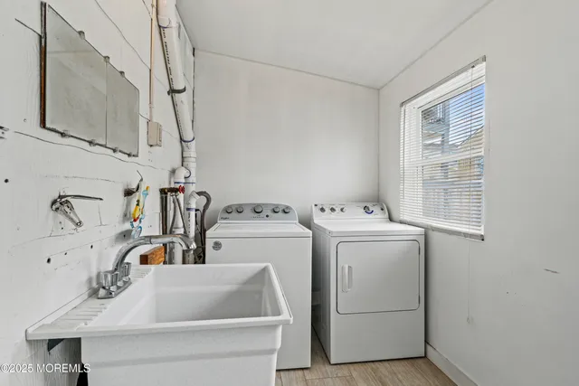 a kitchen with a sink cabinets and wooden floor