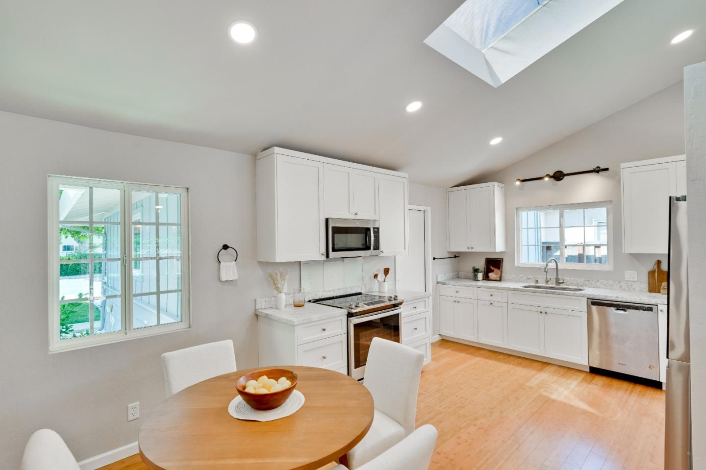 1755 Ravizza Avenue Santa Clara, CA 95051 - Photo 11 of 36 a kitchen with stainless steel appliances granite countertop a stove a sink a refrigerator a dining table and chairs