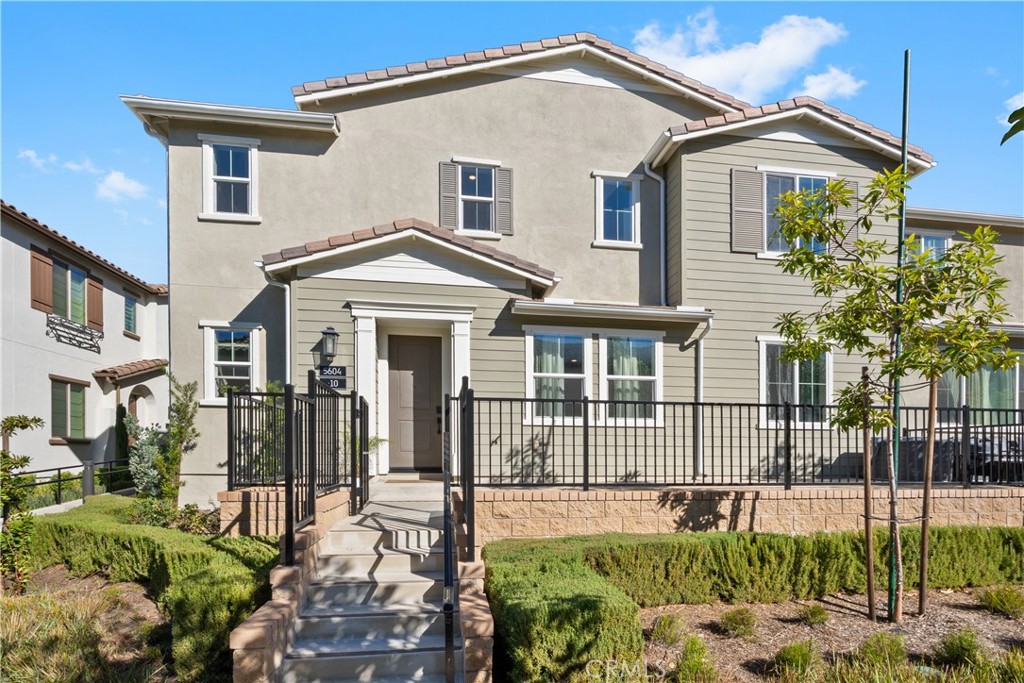 5604 Altamura Way, Unit 10 Fontana, CA 92336 - Photo 1 of 38 a front view of a house with a yard