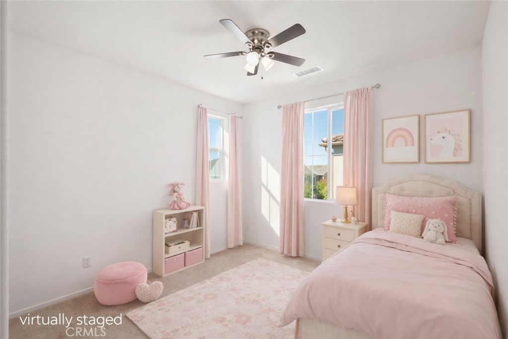 5604 Altamura Way, Unit 10 Fontana, CA 92336 - Photo 13 of 38 a bedroom with a bed and a chandelier
