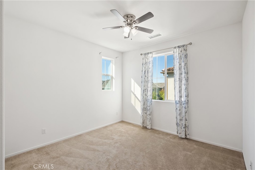 5604 Altamura Way, Unit 10 Fontana, CA 92336 - Photo 14 of 38 an empty room with closet and windows