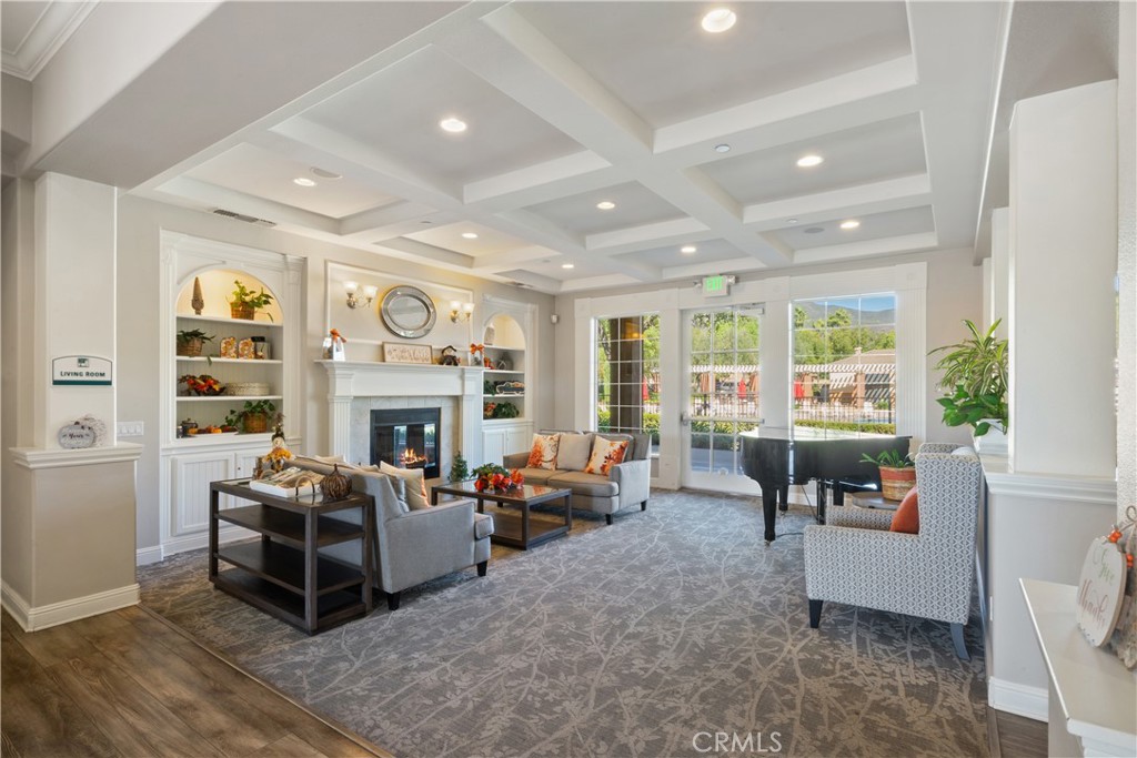 5604 Altamura Way, Unit 10 Fontana, CA 92336 - Photo 22 of 38 a living room with furniture fireplace and a large window