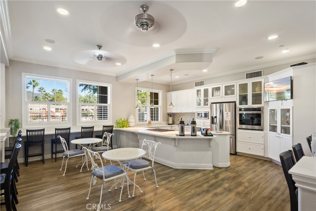 5604 Altamura Way, Unit 10 Fontana, CA 92336 - Photo 23 of 38 a large kitchen with a table and chairs