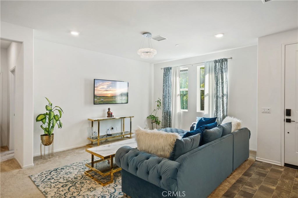 5604 Altamura Way, Unit 10 Fontana, CA 92336 - Photo 3 of 38 a living room with furniture and a potted plant