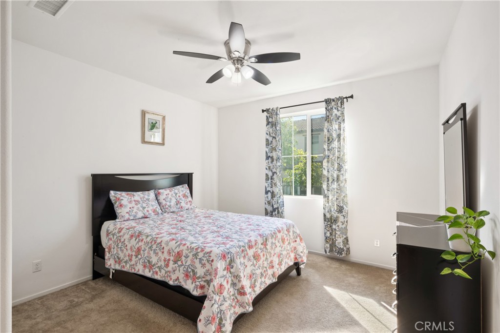 5604 Altamura Way, Unit 10 Fontana, CA 92336 - Photo 8 of 38 a bedroom with a bed table and a window