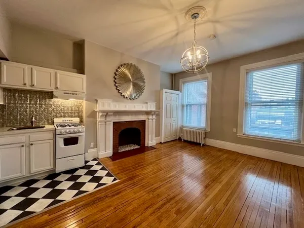 a view of kitchen and hall with wooden floor