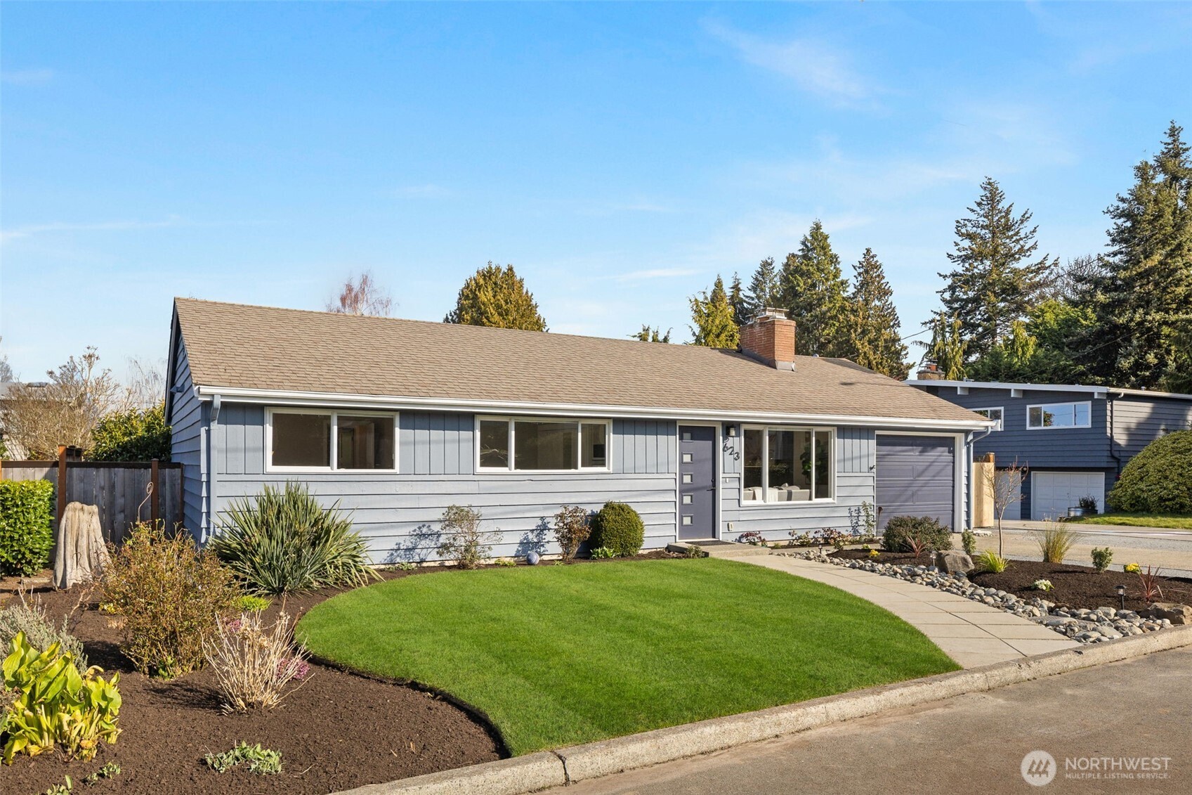 a front view of house with yard and green space