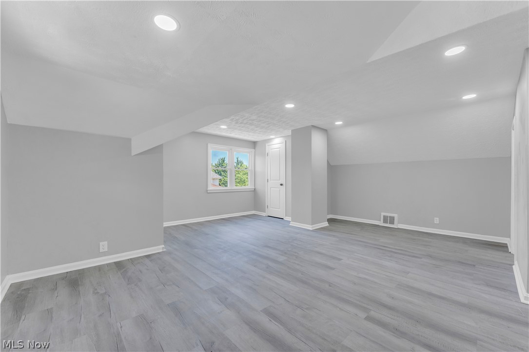5581 Dunham Road Maple Heights, OH 44137 - Photo 24 of 33 Bonus room with lofted ceiling and wood-type flooring