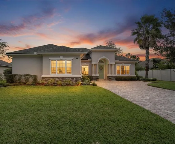 a front view of a house with a garden