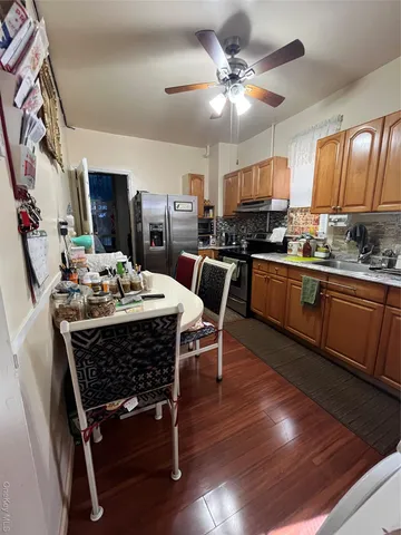 a view of a dining room with furniture a rug and wooden floor
