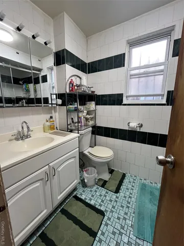 a bathroom with a sink a toilet and a mirror