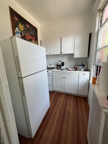 a white refrigerator freezer sitting inside of a kitchen