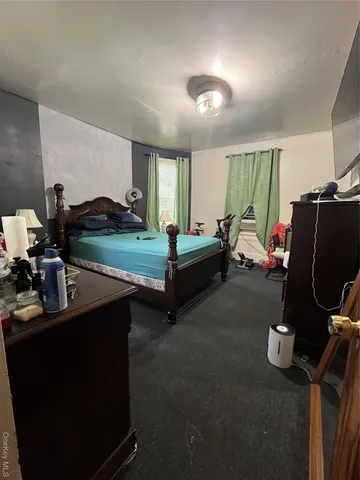 a bedroom with furniture and a car parked