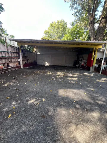 a view of outdoor space with deck and car parked