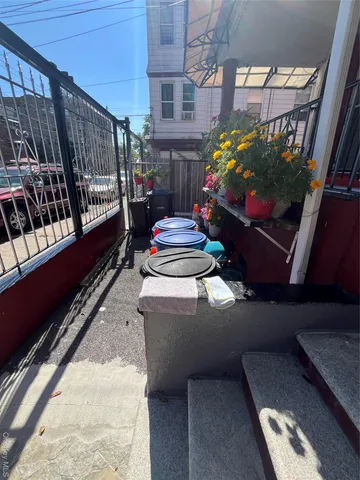 a balcony with chairs and wooden floor