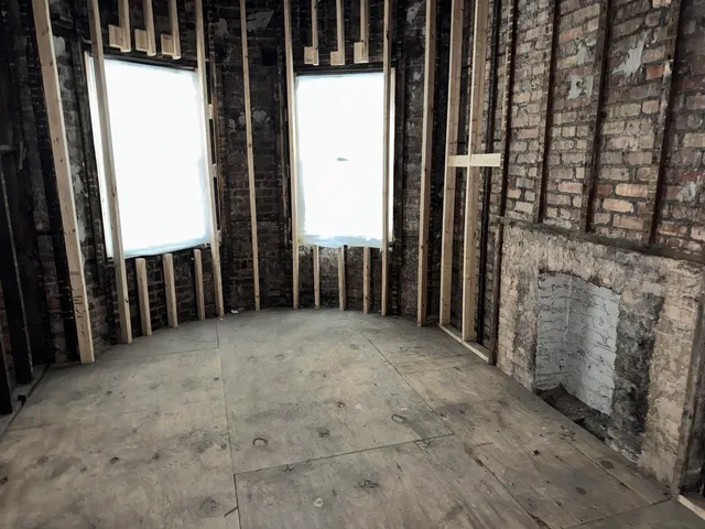 a view of a porch with wooden fence
