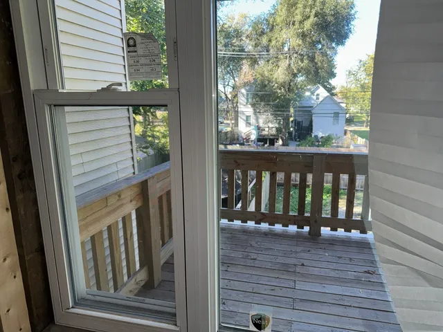 a view of a balcony with wooden floor