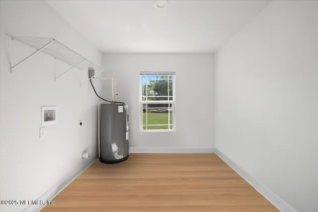 a view of a room with wooden floor and windows