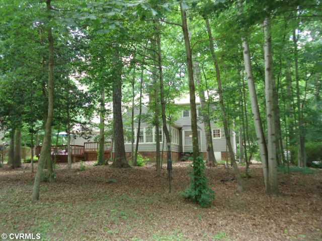 1431 Kingscross Road Midlothian, VA 23114 - Photo 2 of 21 Exterior Back - Large wooded backyard creates serene and private views from Florida room, kitchen, and deck.
