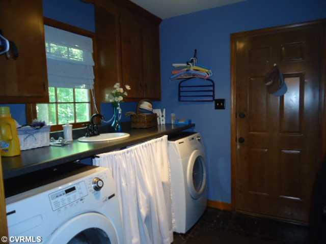 1431 Kingscross Road Midlothian, VA 23114 - Photo 18 of 21 Laundry - First floor laundry located between family room and garage. Note folding table, cabinets and sink. Vinyl flooring. Storage area under sink.