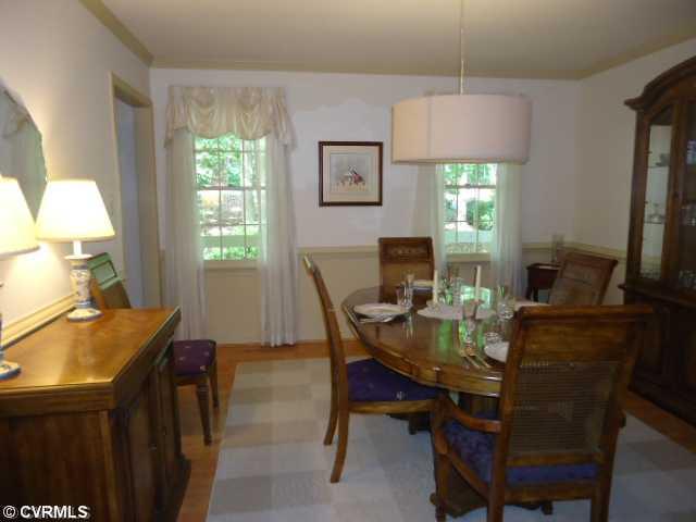 1431 Kingscross Road Midlothian, VA 23114 - Photo 4 of 21 Dining Room - Crown molding, double chair rail moldings, laminate (wood style) flooring.