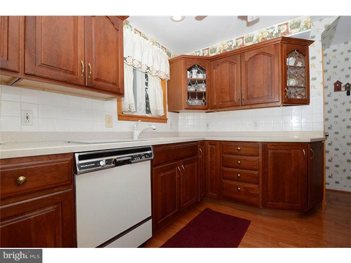 332 East Manoa Road Havertown, PA 19083 - Photo 5 of 14 a kitchen with granite countertop wooden cabinets and stainless steel appliances