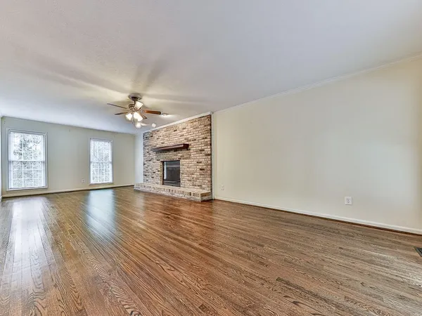 wooden floor in an empty room with a window