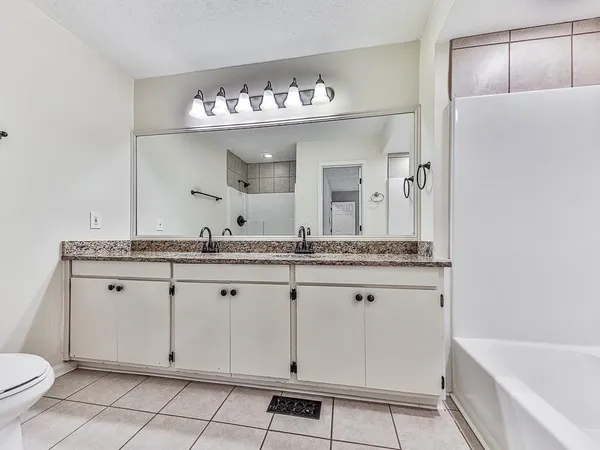 a bathroom with a sink double vanity and a mirror