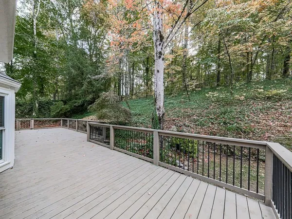 a view of balcony with deck and trees