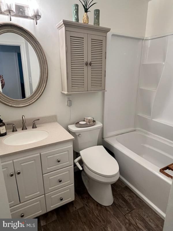 5823 Deale Beach Road Deale, MD 20751 - Photo 5 of 15 a bathroom with a granite countertop toilet sink and mirror
